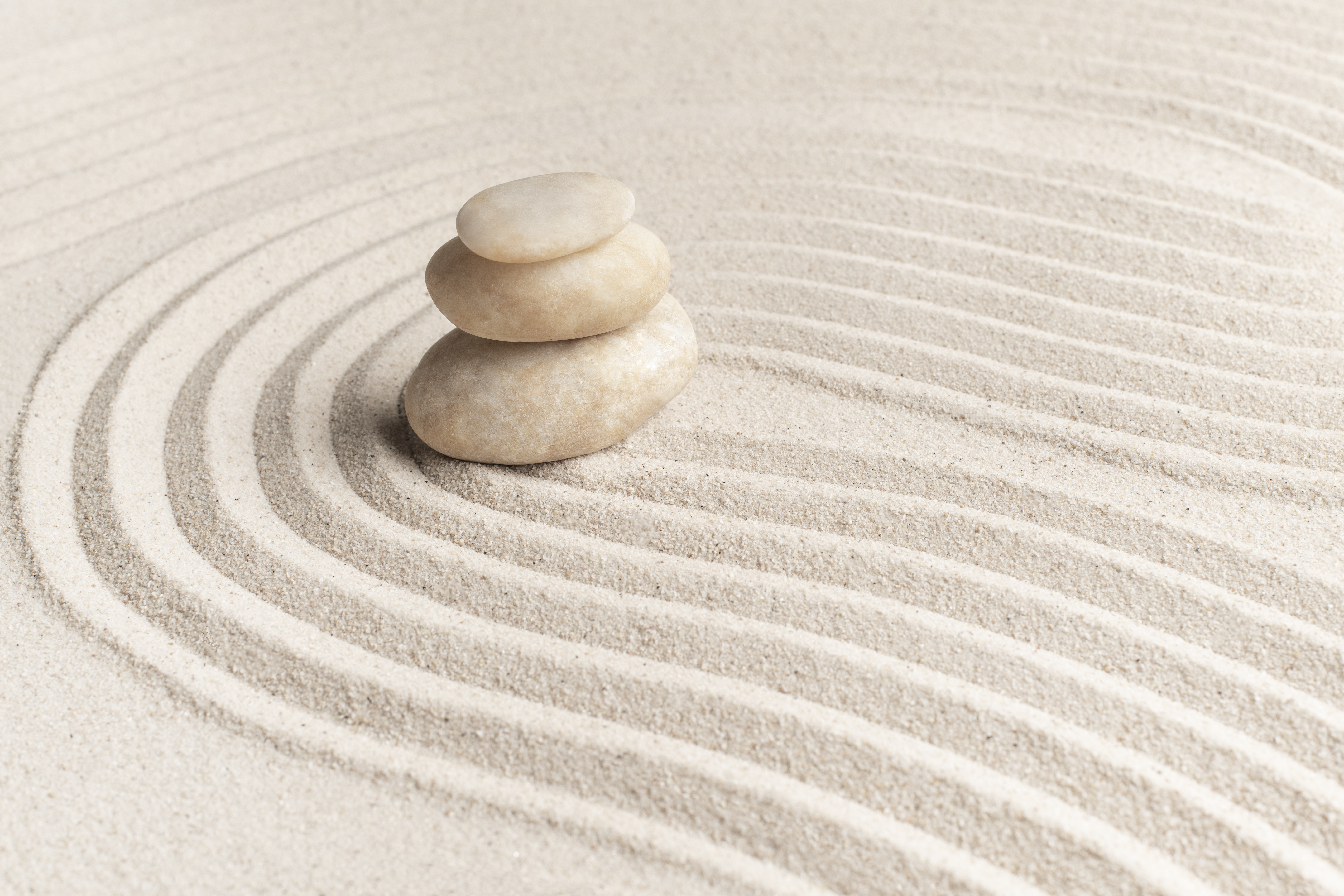 Stacked zen stones in sand